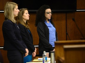 From left, Defense attorneys Kathryn Herold and Jen Beck stand with Dynel Lane as the jury enters the courtroom before closing statements in Boulder, Colo., on Monday, Feb. 22, 2016. Lane is charged with attempted murder, unlawful termination of a pregnancy and four counts of felony assault. (Matthew Jonas/Daily Camera via AP)