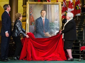Former Ontario premier Dalton McGuinty watches his successor, Kathleen Wynne, left, and Lt.-Gov. of Ontario Elizabeth Dowdeswell, right, unveil his official portrait at Queen's Park in Toronto on Tuesday, February 23, 2016. (THE CANADIAN PRESS/Mark Blinch)