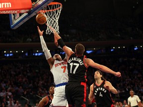 New York Knicks forward Carmelo Anthony battles with Toronto Raptors centre Jonas Valanciunas during third-quarter NBA action at Madison Square Garden in New York on Feb. 22, 2016. (Anthony Gruppuso/USA TODAY Sports)