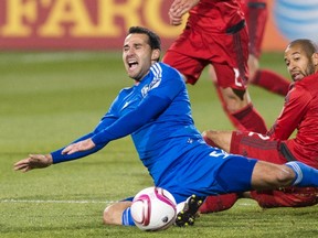 Toronto FC’s Justin Morrow takes down Montreal’s Dilly Duka during their playoff game last year. (THE CANADIAN PRESS)