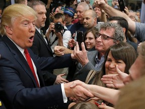 Republican U.S. presidential candidate Donald Trump greets caucus goers as he visits a Nevada Republican caucus site at Palo Verde High School in Las Vegas, Nevada February 23, 2016.    REUTERS/Jim Young