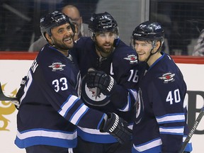 Winnipeg Jets left winger Andrew Ladd (c) celebrates his second period goal against the Dallas Stars with  defenceman Dustin Byfuglien (l) and right winger Joel Armia during NHL hockey in Winnipeg, Man. Tuesday February 23, 2016. Byfuglien and Armia assisted on the goal.
Brian Donogh/Winnipeg Sun/Postmedia Network
