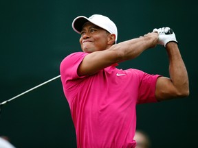 Tiger Woods released a short video showing him swinging a 9-iron in a golf simulator, in response to a report he could no longer sit in a chair and spends most of the day lying down. (Rick Scuteri/AP Photo/File)