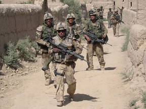 Canadian troops from 9 Platoon, C Company, PPCLI, patrol Afghan village of Zangadin for Taliban, on June 14, 2006. THE CANADIAN PRESS/John Cotter