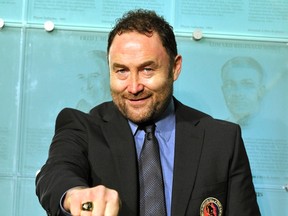 Ed Belfour, seen here showing his Hockey Hall of Fame induction ring in 2011, auctioned off an Olympic gold medal and other items to fund a distillery with his son. (Mike Cassese/Reuters/Files)