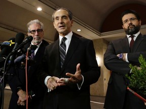 Plaintiffs attorney Joseph Cammarata, center, speaks as attorneys Ira Sherman, left, and Michael Bressler, right, listen during a news conference, Monday, Feb. 22, 2016, in Springfield, Mass. after a deposition of Camille Cosby, wife of Bill Cosby. Bill Cosby's wife finished hours of answering questions under oath in a Massachusetts defamation lawsuit filed against him by seven accusers. Camille Cosby has publicly stood by her husband despite the dozens of sexual-assault allegations against him. (AP Photo/Elise Amendola)