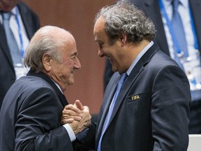 In this Friday, May 29, 2015 file photo, FIFA president Sepp Blatter is greeted by UEFA President Michel Platini, right, at the Hallenstadion in Zurich, Switzerland. (Patrick B. Kraemer/Keystone via AP, File)