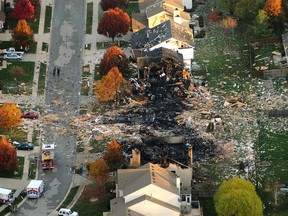 In this Nov. 11, 2012 file aerial photo, two homes that were leveled and the numerous neighboring homes that were damaged from a massive explosion that sparked a huge fire and killed two people are shown in Indianapolis. (Matt Kryger/The Indianapolis Star via AP, File)