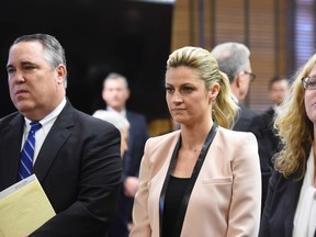 Sportscaster and TV host Erin Andrews (centre) attends a hearing in Nashville, Tenn., on Tuesday, Feb. 23, 2016. Andrews has filed a $75 million lawsuit against the franchise owner and manager of a luxury hotel and a man who admitted to making secret nude recordings of her in 2008. (Samuel M. Simpkins/The Tennessean via AP)