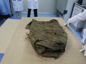 A forensic expert shows a rucksack with blood stains where the skull of missing U.S. tourist Yvonne Baldelli was found, after matching her DNA at the Forensic Institute in Panama City August 29, 2013. (REUTERS/Carlos Jasso)