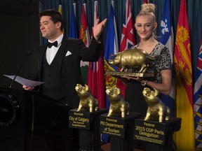 Canadian Taxpayers Federation Federal Director Aaron Wudrick gestures to the winners of the 18th annual Teddy Government Waste awards during a news conference on Parliament Hill, Wednesday February 24, 2016 in Ottawa. THE CANADIAN PRESS/Adrian Wyld