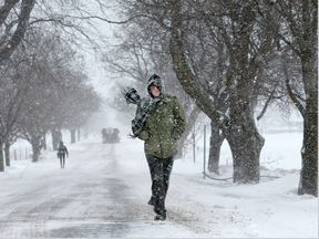 Alex Jones walks through the Experimental Farm in Ottawa Wednesday in blizzard conditions as the winds picked up. (Julie Oliver/Postmedia)