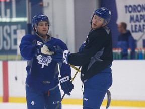Toronto Maple Leafs Brendan Leipsic and Morgan Rielly exchange sticks during practice at the Mastercard Centre on Feb. 24, 2016. (Jack Boland/Toronto Sun/Postmedia Network)