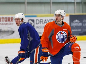 Justin Schultz, right, takes a breather with Connor McDavid at practice Wednesday in Leduc. (Ian Kucerak)
