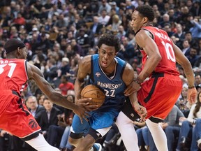 Minnesota Timberwolves guard Andrew Wiggins drives past Toronto Raptors' DeMar DeRozan and Terrence Ross during second-half NBA action at the Air Canada Centre in Toronto on Feb. 24, 2016. (THE CANADIAN PRESS/Nathan Denette)