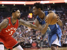 Timberwolves’ Andrew Wiggins squares up against the Raptors’ James Johnson on Wednesday night. (USA TODAY)
