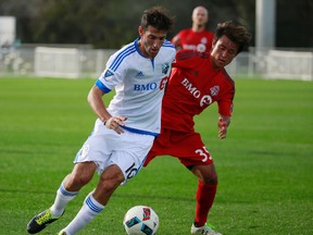 Tsubasa Endoh of TFC (right) challenges Ignacio Piatti during last night's friendly against the Montreal Impact (Kim Klement, USA Today Sports)