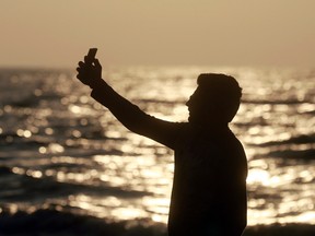 In this Feb. 22, 2016, photo, an Indian man takes a selfie in Mumbai's coastline. India is home to the highest number of people who have died while taking photos of themselves, with 19 of the world’s 49 recorded selfie-linked deaths since 2014, according to San Francisco-based data service provider Priceonomics. The statistic may in part be due to India’s sheer size, with 1.25 billion citizens and one of the world’s fastest-growing smartphone markets. (AP Photo/Rafiq Maqbool)