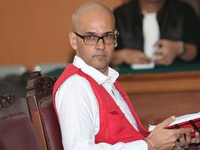 Canadian teacher Neil Bantleman sits on the defendant's chair prior to the start of his trial hearing at South Jakarta District Court in Jakarta, Indonesia, Monday, Dec. 2, 2014. THE CANADIAN PRESS/AP, Tatan Syuflana