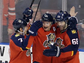 Panthers right wing Jaromir Jagr (68) celebrates with teammates Jussi Jokinen (36) and Dmitry Kulikov (7) after scoring against the Jets during second period NHL action in Sunrise, Fla., on Saturday, Feb. 20, 2016. (Alan Diaz/AP Photo)
