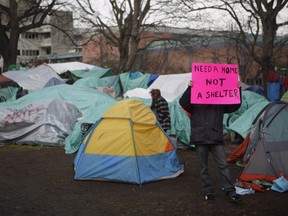 Residence of a homeless camp are shown in Victoria on Monday, January 11, 2016. Police in Victoria say they won't immediately enforce a Thursday deadline aimed at clearing residents from a tent encampment in the city's downtown core. (THE CANADIAN PRESS/Chad Hipolito)
