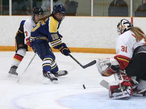 Laurentian Voyageurs' Ellery Veerman gets a shot on Guelph Gryphons goalie Valerie Lamenta during OUA women's hockey playoff action at Gerry McCrory Countryside Sports Complex on Wednesday night.