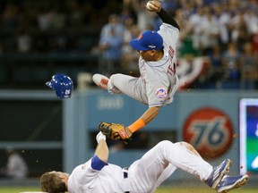 Major League Baseball and the players' association have banned rolling block slides to break up potential double plays, hoping to prevent a repeat of the takeout by Dodgers' Chase Utley (bottom) that broke a leg of Mets' Ruben Tejada (top) in last year’s playoffs. (Gregory Bull/AP Photo/Files)