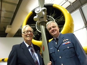 Ernst Kuglin/The Intelligencer
Flight Officer Jim Moffat and 8 Wing/CFB Trenton Commanding Officer, Col Colin Keiver, stand under the engine of a Harvard trainer at Thursday’s official launch of the Quinte International Air Show. The air show that takes flight on June 25 and 26 will commemorate the British Commonwealth Air Training Plan (BCATP) and the 75th anniversary of the 400 series of squadrons, designations still in use by the Royal Canadian Air Force (RCAF). Moffat received his training at Trenton before he deployed overseas during World War 2.