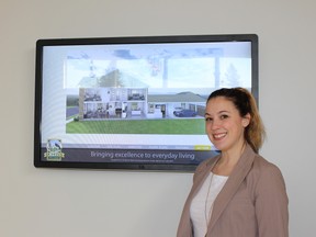 Victoria Danks, shows an interactive screen that lets potential buyers see what their new home will look like on a 360 degree rotation. Home buyers excitedly swarmed the Duffin’s Village sales office last weekend.