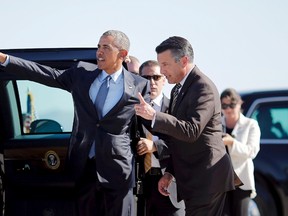 U.S. President Barack Obama talks to Nevada Governor Brian Sandoval (R) as he arrives at McCarran International Airport in Las Vegas, Nevada in this August 24, 2015 file photo.   REUTERS/Carlos Barria/Files