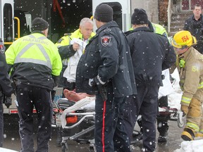 A man is placed on a stretcher to be taken to hospital with possible hypothermia in Kingston, Ont. on Thursday, Feb. 25, 2016 after he was rescued from a swamp off Kananaskis Drive in Westbrook, in the city's west end. He was naked and was stuck in about a metre of icy water when police and firefighters arrived. Police suspect substance abuse or a mental health issue as the cause for his actions. Michael Lea The Whig-Standard Postmedia Network