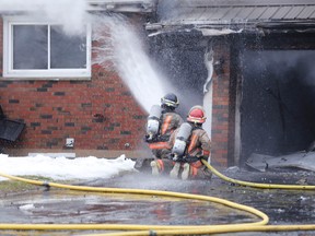 JASON MILLER/THE INTELLIGENCER
Belleville firefighters tackle a blaze which engulfed a Point Anne home Thursday afternoon.  No injuries were sustained during the fire which early reports indicate started in the garage of the bungalow home following a power outage.