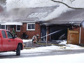 Belleville firefighters tackle a blaze which engulfed a Point Anne home Thursday afternoon.  No injuries were sustained during the fire which early reports indicate started in the garage of the bungalow home following a power outage. Jason Miller/ Belleville Intelligencer/Postmedia Networ