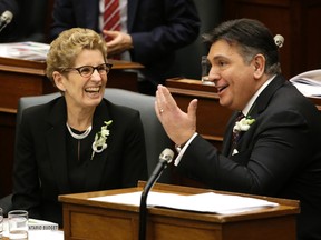 Finance Minister Charles Sousa presents the province's 2016 budget with Premier Kathleen Wynne looking on in Toronto, today.
Craig Robertson/Postmedia Network