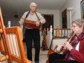 Jason Hawke and Heather Schreiner, members of the Melos Choir and Period Instruments, play music on a hurdy-gurdy and a crumhorn, respectively, at Hawke’s home. The choir, which performs music of the 12th to 18th centuries, plays a concert on Feb. 27 at St. George's Cathedral Great Hall. (Julia McKay/The Whig-Standard)