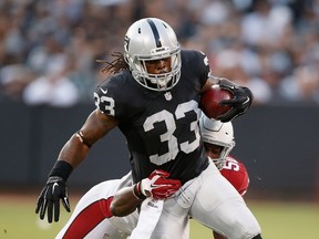 Trent Richardson of the Oakland Raiders is tackled by Gabe Martin of the Arizona Cardinals at O.co Coliseum in Oakland on Aug. 30, 2015. (Ezra Shaw/Getty Images/AFP)