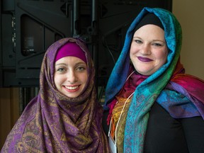 Barbara Neuwelt gets help trying on a hijab as Ottawa Hijab Solidarity Day was held at Ottawa City Hall to help draw attention to Islamophobia and to learn more from Muslim women about the wearing of the hijab. (Wayne Cuddington)