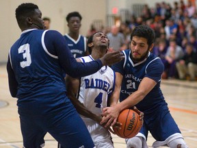 Beal?s Abel Emun is fouled as he drives between CCH?s Daniel Johnson and Sebastian Vanin during their WOSSAA AAA senior boys basketball semifinal at Clarke Road on Thursday. (MIKE HENSEN, The London Free Press)
