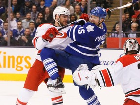 Toronto Maple Leafs right winger P.A. Parenteau battles with Carolina Hurricanes defenceman Michal Jordan in front of the net in first-period NHL action at the Air Canada Centre in Toronto on Feb. 25, 2016. (Stan Behal/Toronto Sun/Postmedia Network)