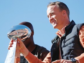 Denver Broncos quarterback Peyton Manning holds the Lombardi Trophy during a parade for the Super Bowl champions in Denver on Feb. 9, 2016. (AP Photo/Jack Dempsey)