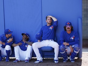 A group of Toronto Blue Jays players try to stay cool in the shade before the game against the Pittsburgh Pirates at Florida Auto Exchange Stadium in Dunedin, Fla., on March 3, 2015. (Joe Robbins/Getty Images/AFP)