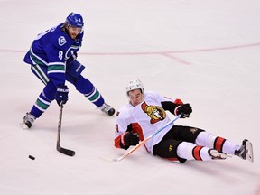 Ottawa Sentators forward Mark Stone goes down against Vancouver Canucks defenceman Christopher Tanev during the second period at Rogers Arena in Vancouver on Feb. 25, 2016. (Anne-Marie Sorvin/USA TODAY Sports)