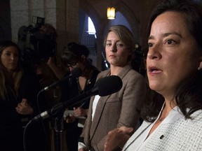 Heritage Minister Melanie Joly (left) looks on as Minister of Justice and Attorney General of Canada Jody Wilson-Raybould speaks with the media about the Special Joint Committee on Physician-Assisted Dying report tabled in Ottawa, Thursday February 25, 2016. THE CANADIAN PRESS/Adrian Wyld