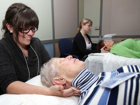 Luke Hendry/The Intelligencer
Registed massage therapist Nicole Conroy, of Brighton, treats Eileen Robbins, of Picton, during an Alzheimer Society retreat in Belleville Friday. The five-hour break for caregivers of people with dementia runs twice a year.