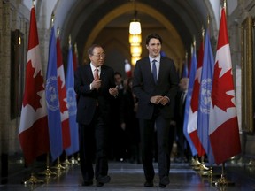 Canada's Prime Minister Justin Trudeau (R) walks with United Nations Secretary-General Ban Ki-moon following a news conference on Parliament Hill in Ottawa, Canada, February 11, 2016. REUTERS/Chris Wattie