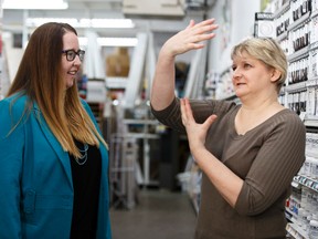The Paint SPOT art store owner Kim Fjordbotten (right) gives Alberta's Minister of Labour, Christina Gray, a tour after a press conference where Gray encouraged employers to apply for the Summer Temporary Employment program in Edmonton, Alta., on Friday February 26, 2016. Fjordbotten's art store has used the program in the past. Photo by Ian Kucerak