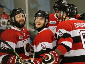 67’s rookie Austen Keating (centre) celebrates a goal with Nathan Todd (left) and Ryan Orban against the Sudbury Wolves on Feb. 26. (Wayne Cuddington, Postmedia Network)