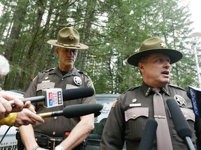 Mason County Sheriff Casey Salisbury, right, talks to reporters as Chief Criminal Deputy Ryan Spurling looks on at left near the scene of a fatal shooting, Friday, Feb. 26, 2016, near Belfair, Wash. (AP Photo/Ted S. Warren)
