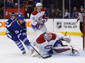 Toronto Maple Leafs forward Joffrey Lupul (19) slips the puck under Montreal Canadiens goalie Mike Condon (39) during the third period in Toronto on Saturday January 23, 2016. (Jack Boland/Toronto Sun/Postmedia Network)
