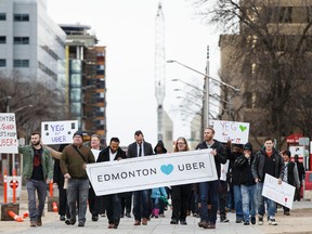 Uber Alberta general manager Ramit Kar (centre left) leads a pro Uber rally to the Alberta Legislature in Edmonton, Alta., on Saturday February 27, 2016. The ride sharing service is asking the provincial government to approve its insurance policy ahead of a March 1 deadline.